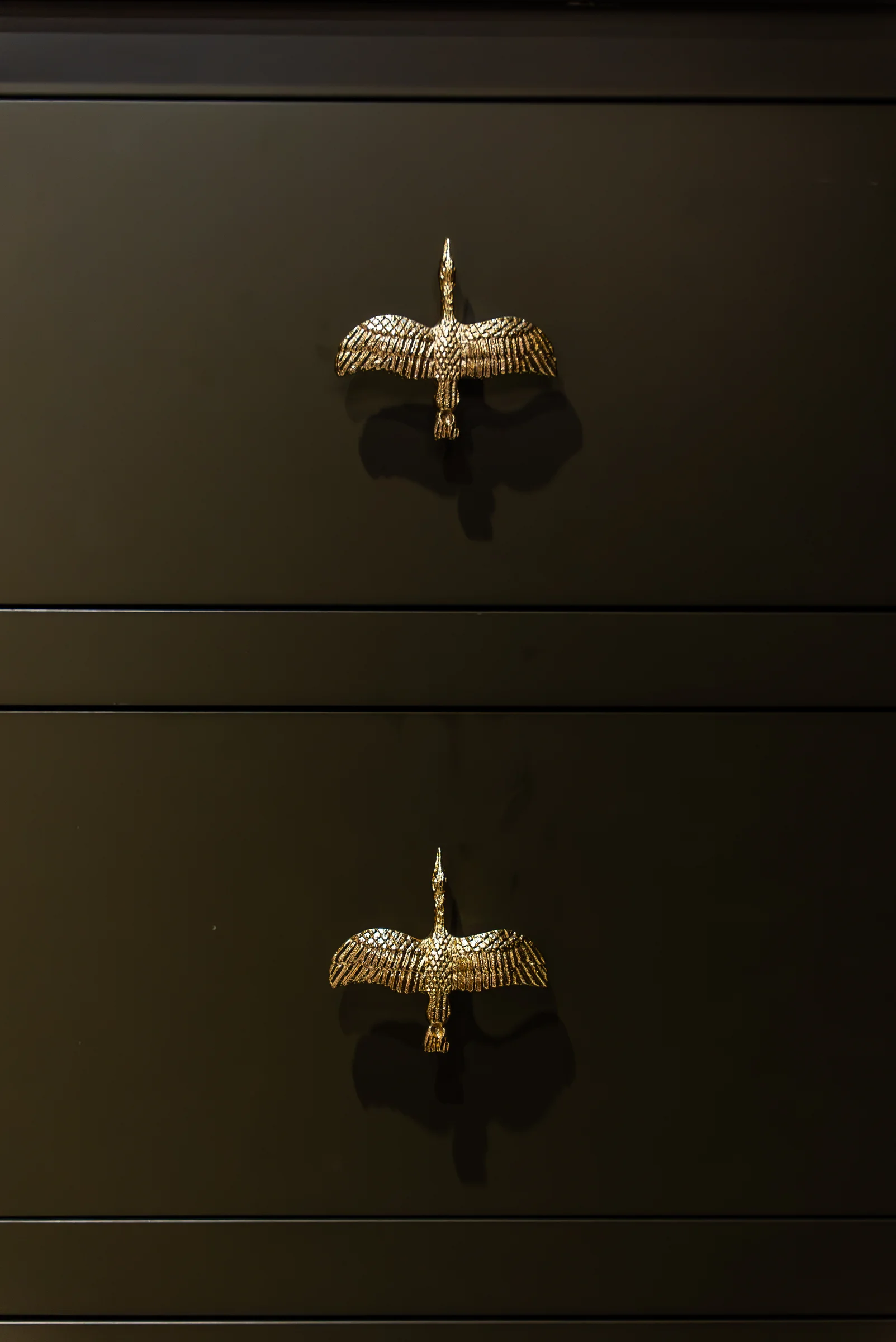 Olive green drawers ornate brass crane bird handles detail