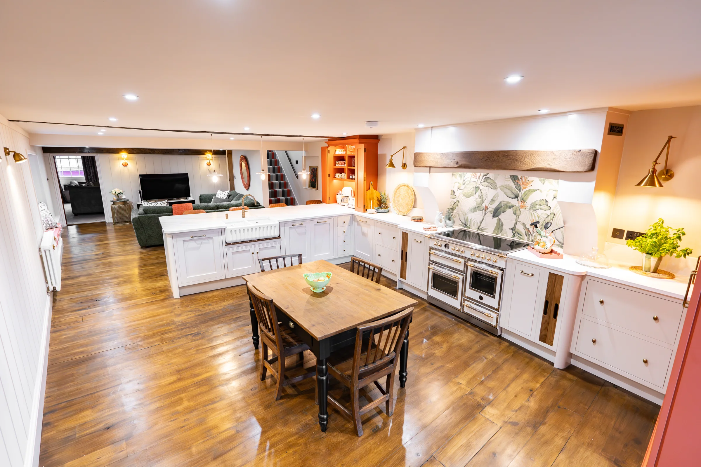 Wide open plan kitchen living white shaker bertazzoni botanical beam orange dresser sofa
